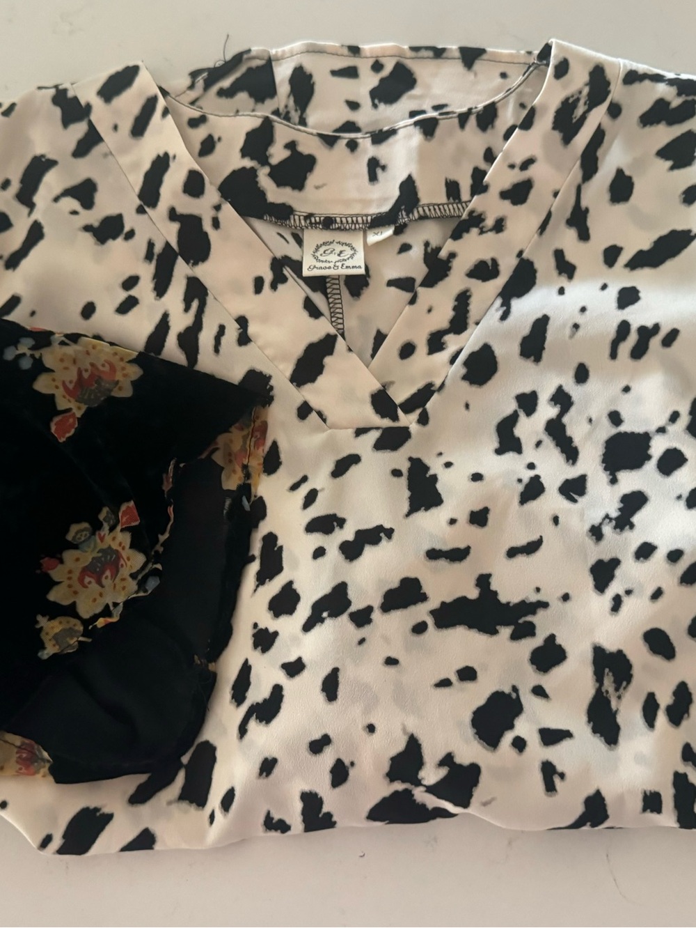 V-Neck Women’s Blouse in Black and White spotted print with floral arm print